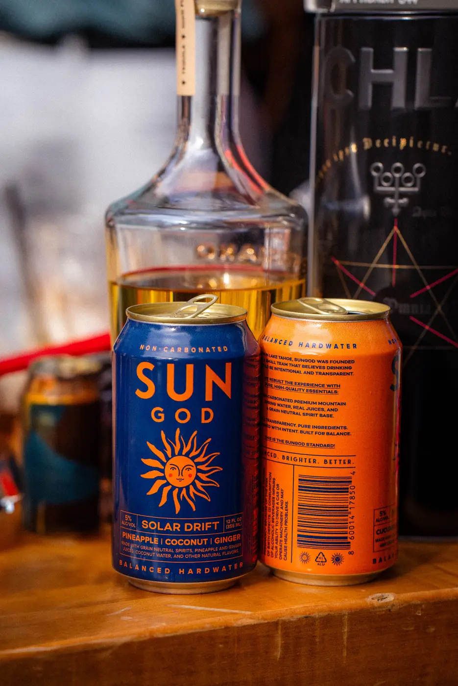 A can of Minted Sol standing next to a tequila bottle on a wood bar