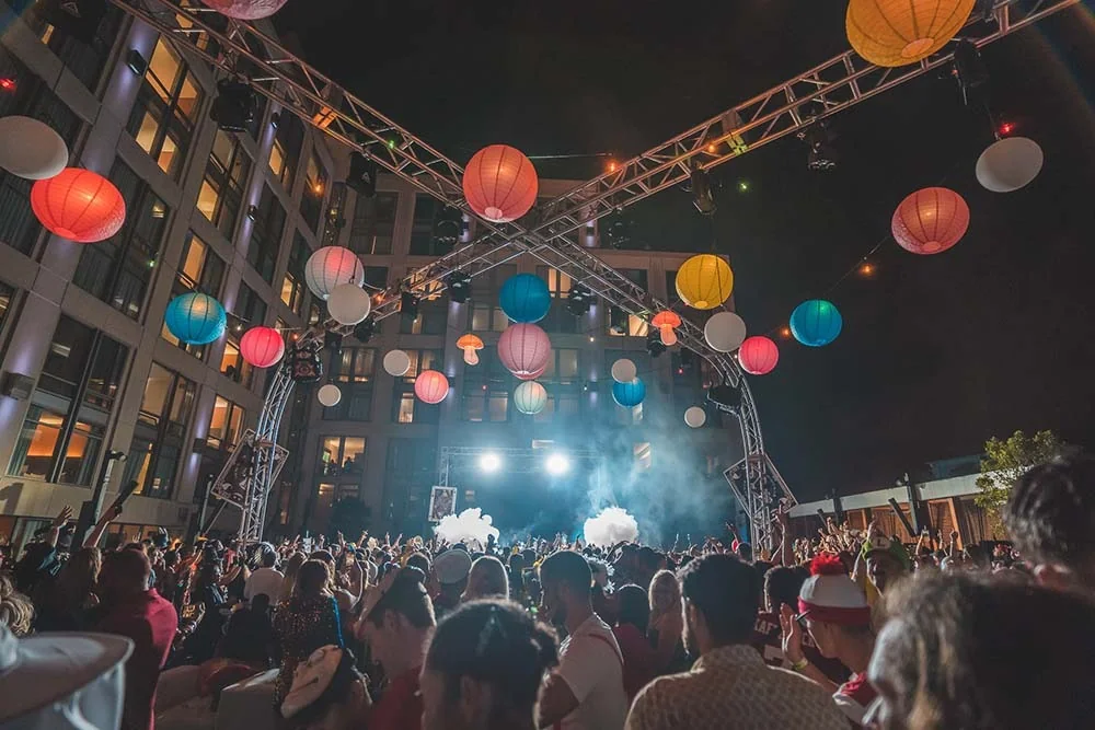 Haunted Manor at the Hard Rock Hotel San Diego, paper lanterns strung over the courtyard crowd with the stage lit up below the hotel
